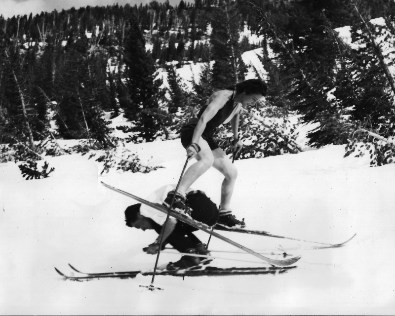 Marcelle Barkely Herz jumping over a fellow skier.