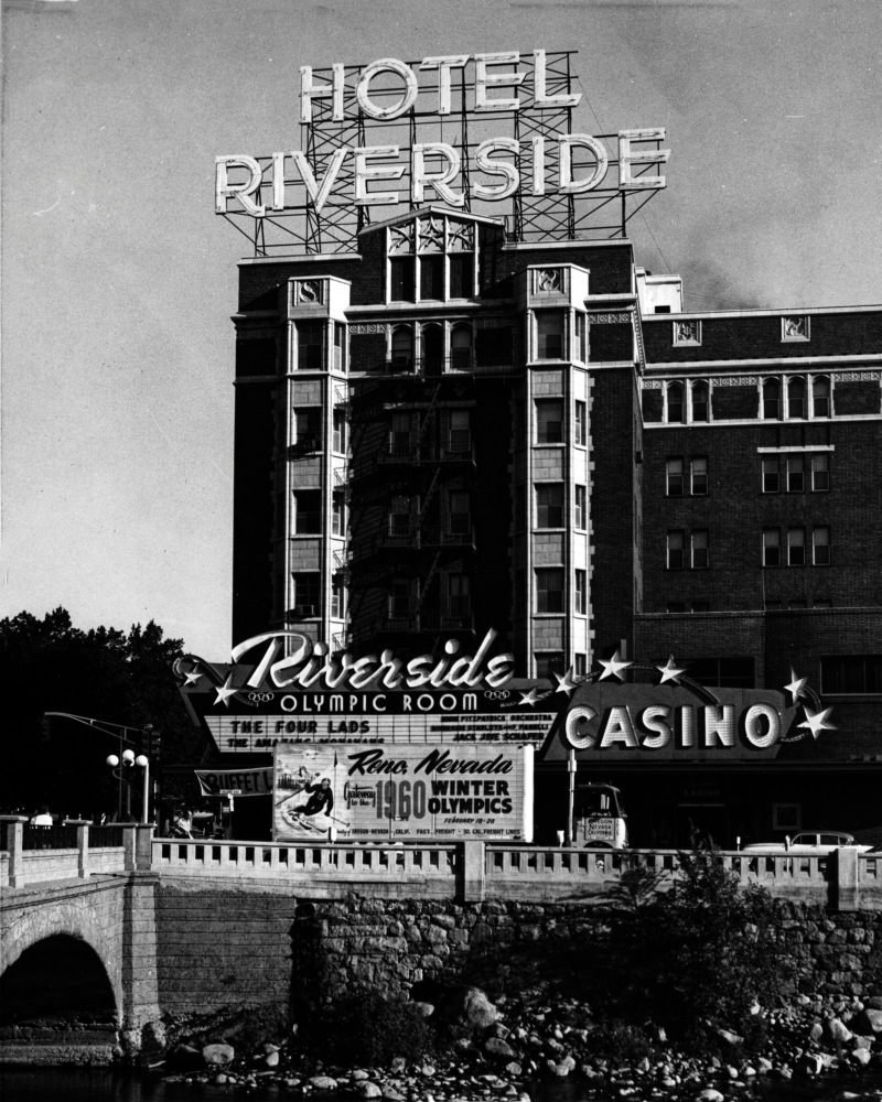 Photograph of freight truck with 1960 Olympics promotional signage parked adjacent to the Hotel Riverside.
